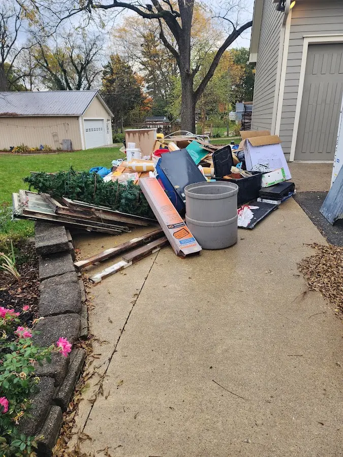 Dumpster being loaded with debris for Estate Cleanout Dumpster Rental in Fulshear